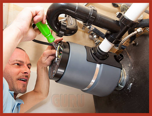 Guru Plumber skilled technician replacing an old garburator with a new unit