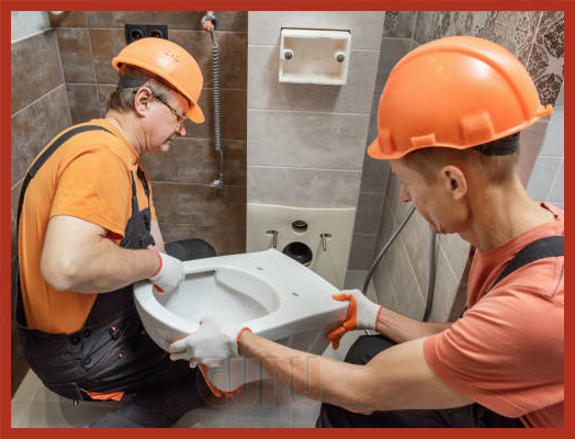 Expert Plumbers Installing a New Toilet